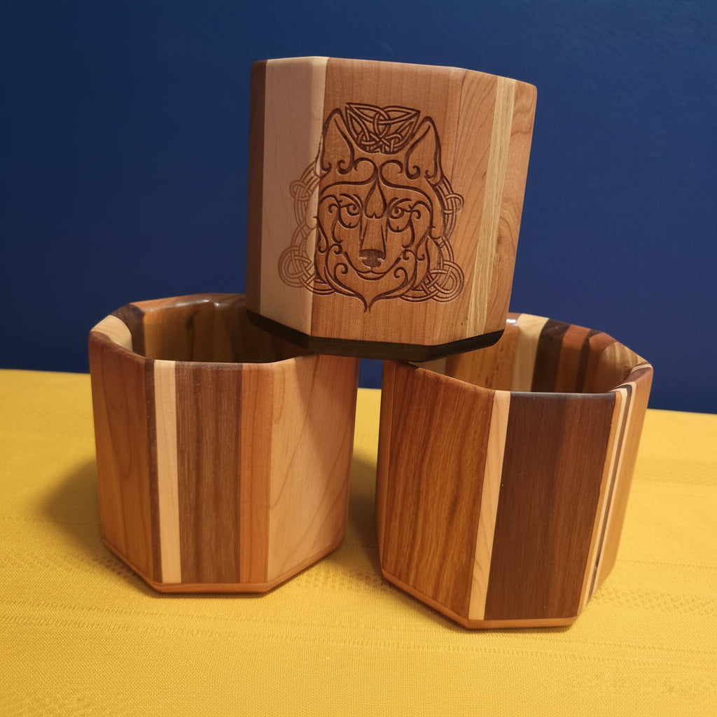 Three handcrafted wooden Viking shot glasses stacked, top cup showing laser-engraved Celtic wolf design
